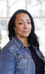 Photo of Tina Hayes wearing a black shirt with a jean jacket.